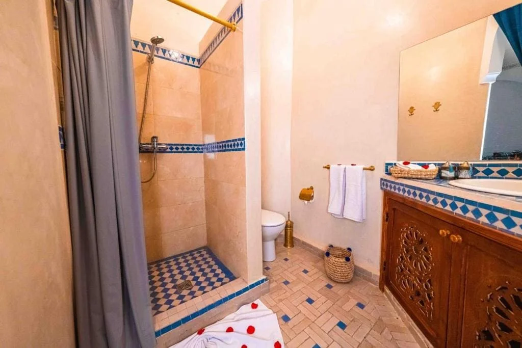 Bathroom at Riad Kiyanjana Marrakech with shower and traditional decor.