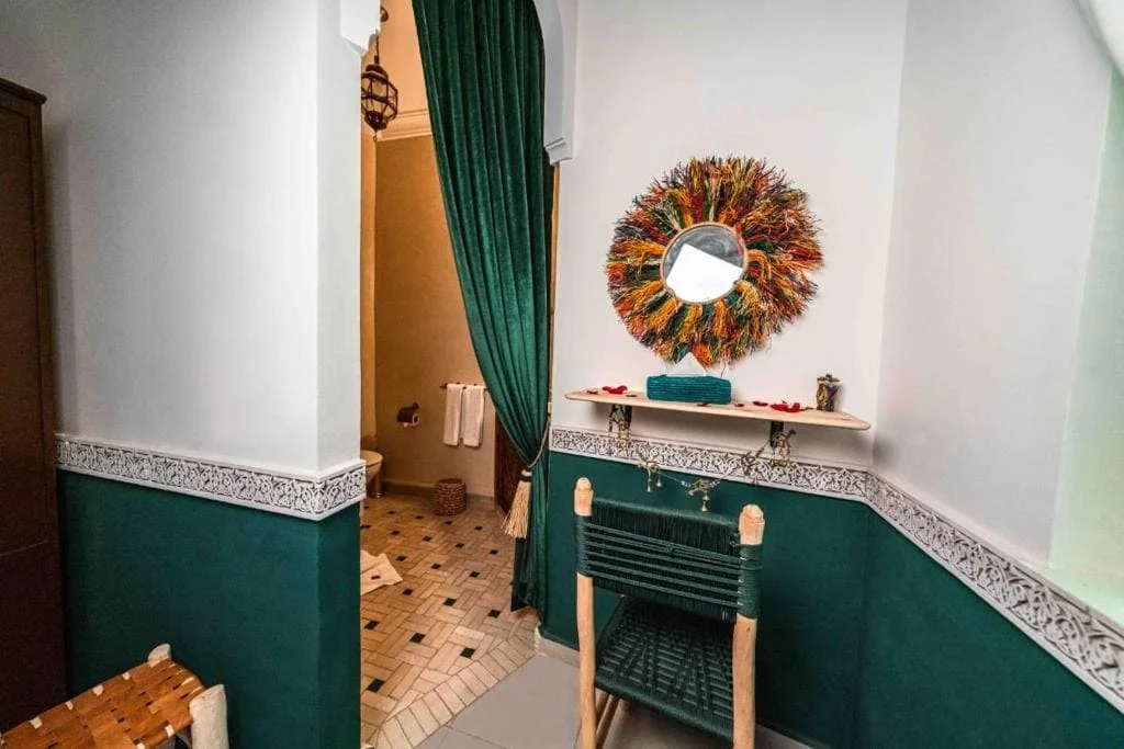 Interior view of Riad Kiyanjana Marrakech with colorful decor and cozy ambiance.