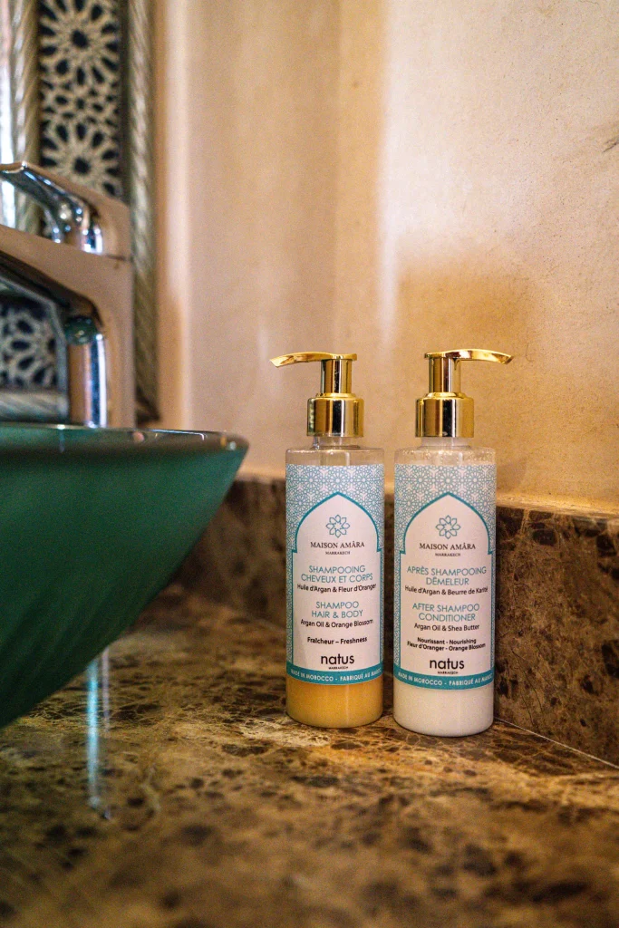 Luxury shampoo and conditioner bottles on marble countertop at Locanda Boutique.