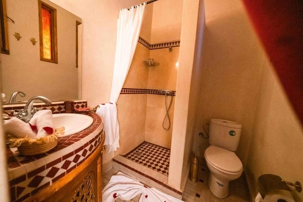 Cozy bathroom with shower, toilet, and elegant decor at Locanda Boutique Collection.