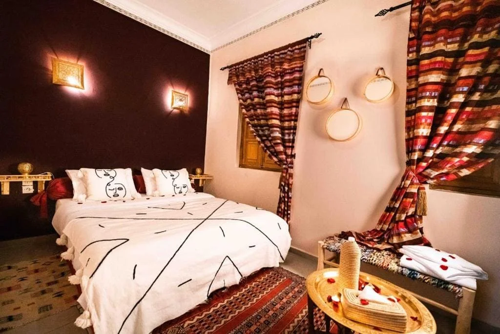 Charming bedroom with Moroccan decor and colorful textiles in Marrakech.