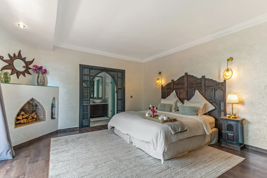 Elegant bedroom with rustic wooden headboard and cozy decor.