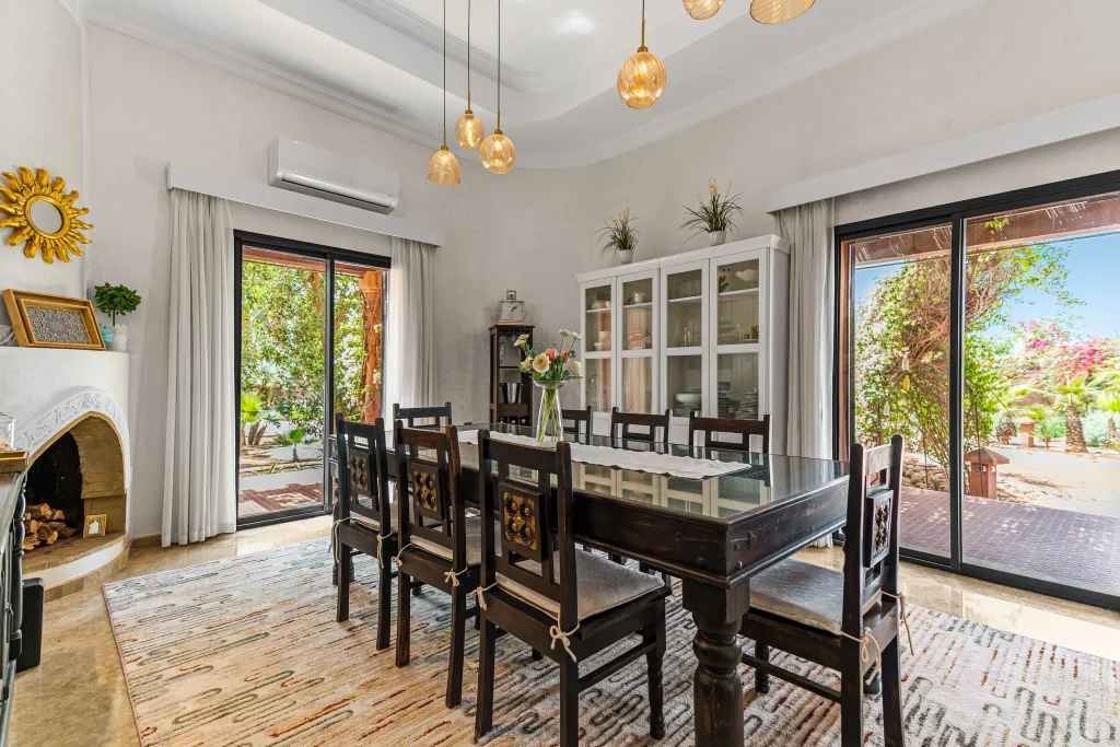 Spacious dining room with large glass doors and modern decor.