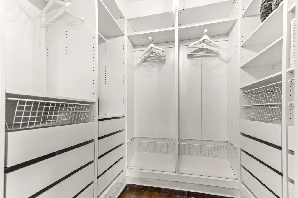Large walk-in closet with shelves, drawers, and hanging space.